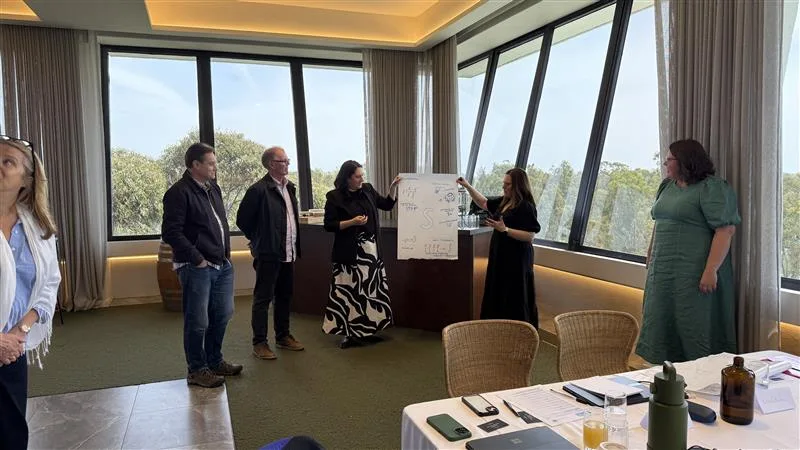 Leaders working through a whiteboard session at a client's offices